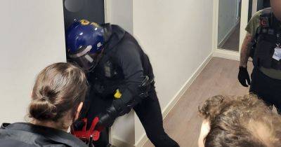 Two women arrested after police storm Greater Manchester home