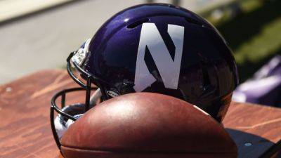 Northwestern AD pushes back on 'tone deaf' T-shirt worn by staff - ESPN