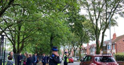 Police stand guard outside 'locked down' schools as worried parents collect their children - manchestereveningnews.co.uk