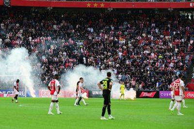 Fans clash with police after Ajax's derby with Feyenoord is abandoned