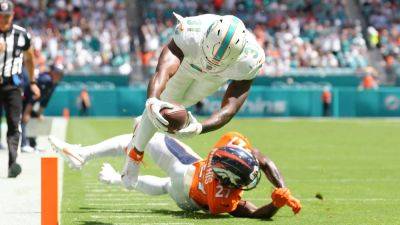 Dolphins turn down record as they devour Broncos