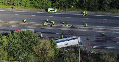M53 crash: Girl, 14, and coach driver dead as school bus overturns in horror smash