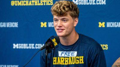 Michigan's JJ McCarthy backs suspended Jim Harbaugh with T-shirt message
