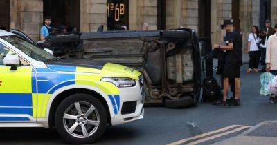 Driver walks away with minor injuries after car dramatically flips after city centre collision - manchestereveningnews.co.uk