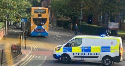 Police close off Wilmslow Road in south Manchester after man is hit by car and rushed to hospital