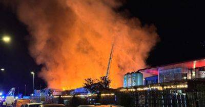 Emergency services at scene as huge fire tears through large city building - live updates