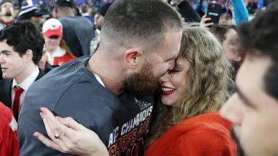 Travis Kelce, Taylor Swift share celebratory kiss as fans wonder if she'll show up to Super Bowl LVIII