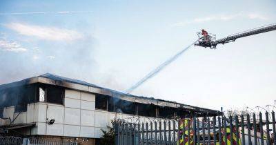 Devastating aftermath of huge fire as crews work at scene - manchestereveningnews.co.uk