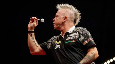 Holder Peter Wright survives scare in Prague