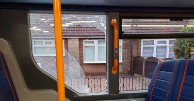 Bus window smashed with a brick while passengers inside