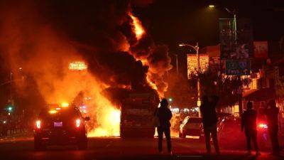 12 arrested, L.A. bus set on fire following World Series win - ESPN