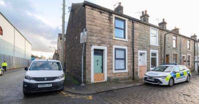 LIVE Police surround terraced row of houses after woman found dead - latest updates