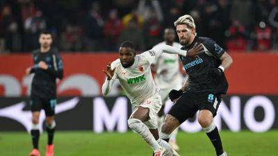 Champions Leverkusen cruise past Augsburg to climb into second spot