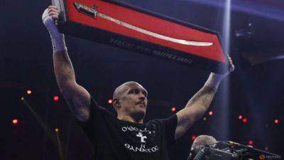 Ukraine's Usyk outpoints Fury to retain world heavyweight crowns