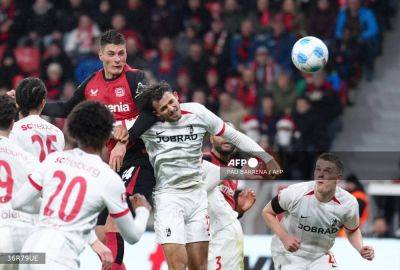 Schick hits four as Leverkusen close gap to Bayern on sombre weekend
