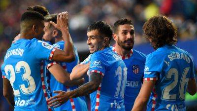 Atletico snatch late win at Barca to top La Liga