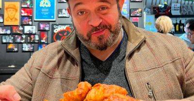 Man v Food star Adam Richman heads to Manchester for fish and chips - and it sparks a debate