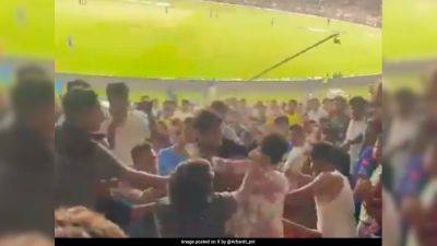 Tim David - Hardik Pandya - Tilak Varma - Gujarat Titans - Video: Punches Exchanged As Fans Come To Blows During GT vs MI Match In Ahmedabad - sports.ndtv.com - India