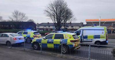 Two arrested as armed police descend on major Trafford road after suspected shooting