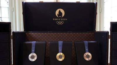 Louis Vuitton makes custom trunks for Paris Games flames, medals
