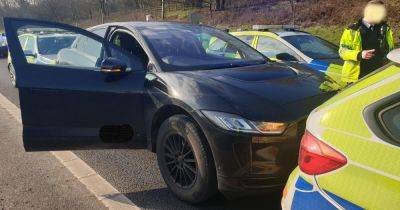 Terror on M62 as police cars swarm carriageway to save driver after electric car can't brake