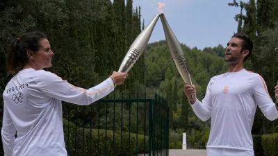 Despite weather glitch, Paris Olympics flame lit at Greek cradle of ancient games