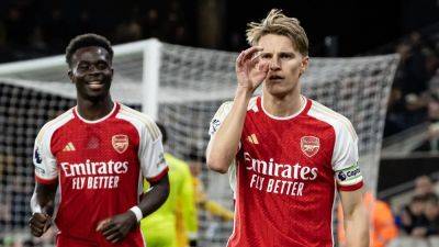 Arsenal climb back to league summit with win at Wolves