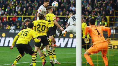Marcel Sabitzer - Florian Wirtz - Josip Stanisic - Late Stanisic goal at Dortmund salvages Leverkusen's unbeaten run - channelnewsasia.com