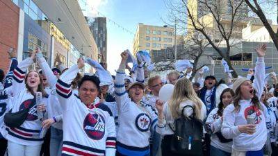 Thousands of Jets fans show up for their team as downtown Winnipeg enters total whiteout conditions
