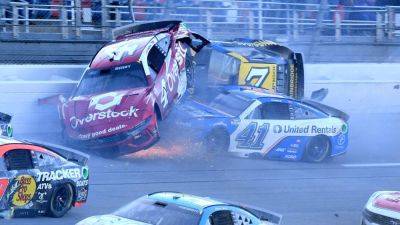 Corey LaJoie crosses start-finish line on his side as he gets caught up in last-lap Talladega crash