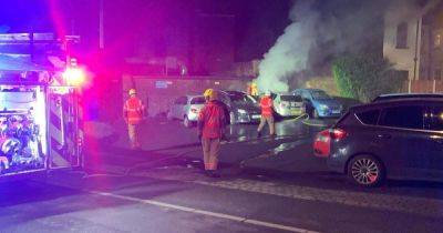 Fire crews rush to street in early hours after car goes up in flames