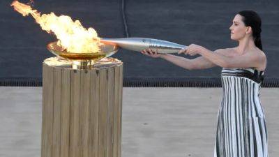 Paris organizers take delivery of Olympic flame at Greek venue of first modern Games
