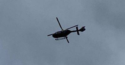 Police helicopter circles town 44 miles away as car linked with crime in Greater Manchester crashes