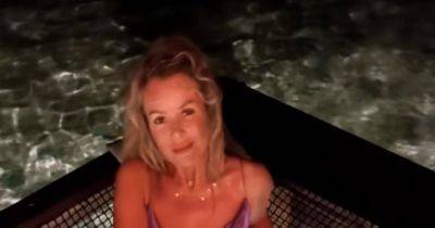 Amanda Holden sends 'back' message as she stuns in tiny bikini while swinging on sea swing