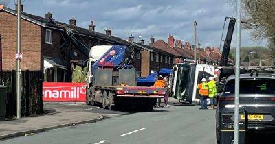 LIVE: Crane topples over in Wigan and 'slices through house'