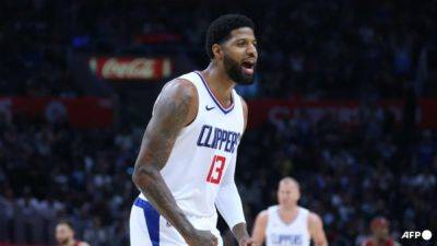 George late show sparks Clippers over Cleveland