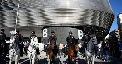 "It feels safe - but there is plenty of caution about": More than 2,000 extra police officers descend on Bernabeu ahead of Man City match after IS threat