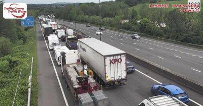 Long queues on M4 after crash between two lorries and car