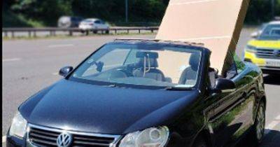 Wild pictures show man driving convertible with huge 60-inch telly hanging out along M60 - manchestereveningnews.co.uk
