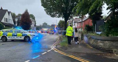 Woman rescued from car after crash into lamppost