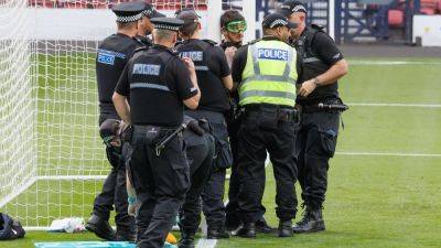 Chained protester delays Scotland v Israel kick-off