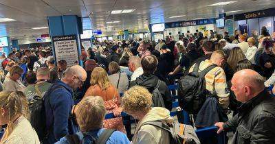 Passengers 'stuck on planes' with 'crazy' queues at border control as 'technical issue' hits Manchester Airport