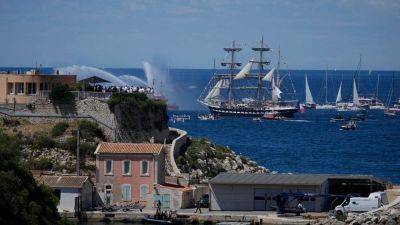 Olympic torch arrives in Marseille on famous ship amid celebration, tight security