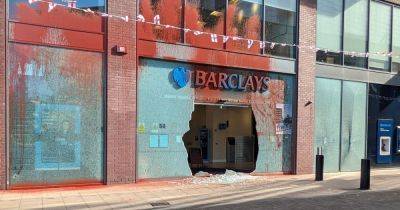 Campaign group Palestine Action smash up TWO Barclays banks in Greater Manchester with police called