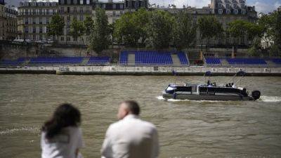 French sports minister takes symbolic dive into river Seine in Paris