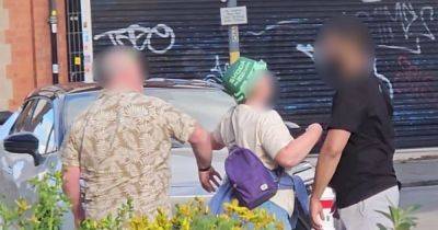 Moment man has phone 'whacked out of his hand' in street row over bollards