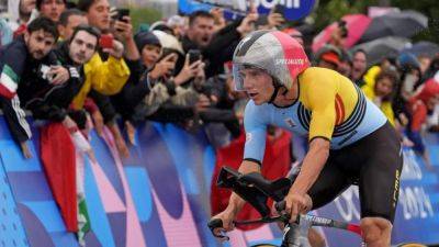 Evenepoel recovers from big night out to win TT gold