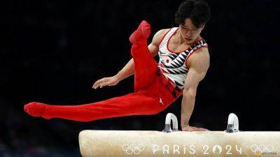 Gymnastics-Bathwater mishap forces Japan's Oka to swap cardboard bed