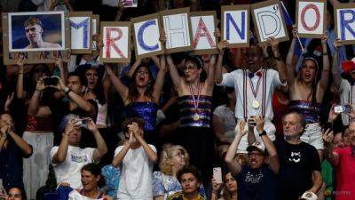 Marchand madness sweeps France as swimmer makes gold rush