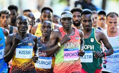 Marathon Great Eliud Kipchoge Hangs Up His Shoes... Literally